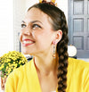 woman in yellow wearing fall earrings